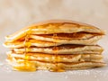 Golden pancakes stacked high, drizzled with syrup. Ai generation