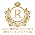 Golden patterned letters with initial monogram in coat of arms form. Shining font and elements kit for logo design