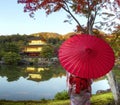 Golden Pavilion or Kinkakuji Temple with red autumn leaves
