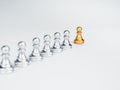 The golden pawn chess piece, leading in front of the group of silver pawn chess pieces.