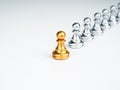 The golden pawn chess piece, leading in front of the group of silver pawn chess pieces.