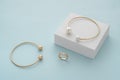 Golden with pearls bracelet on white box and gold bracelet and ring with copy space Royalty Free Stock Photo