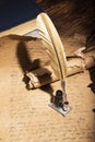 Golden pen and ancient manuscripts