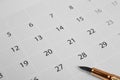 Golden Pen on calendar sheets. Office day and calendar concept Royalty Free Stock Photo
