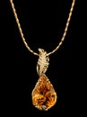 Golden pendant with gem and diamonds