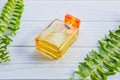 .A golden perfume bottle on a white table