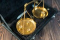 Golden pharmaceutical scales on wooden background. Antique and precision concept