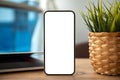 Golden phone with isolated screen on wooden table in office