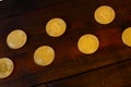 Golden physical bitcoins lies on dark wooden backgound, close up. High resolution photo. Cryptocurrency mining concep