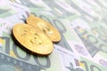 Golden physical bitcoins is lies on a set of green monetary deno