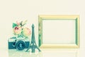 Golden picture frame, flowers and vintage camera. Nostalgic deco