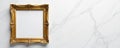 Golden picture frame rests on a large piece of white marble, sleek, modern Royalty Free Stock Photo