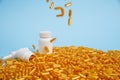 Golden pill capsules on blue background