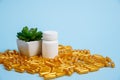 Golden pill capsules on blue background