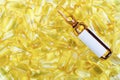 Golden pills and yellow ampoule Royalty Free Stock Photo