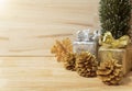 Golden pine cones glittered christmas and gift box decoration on wood table background. copy space Royalty Free Stock Photo