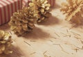 Golden pine cones glittered christmas and gift box decoration on wood table background. copy space Royalty Free Stock Photo