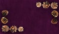 Golden pine cones on a purple velvet as festive table ornament for Hanukkah or Christmas