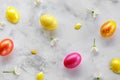 Golden and pink Easter eggs on a marble background with flowers. Royalty Free Stock Photo