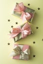 Golden and pink gift box isolated on yellow background. Birthday, Christmas party mock up Royalty Free Stock Photo