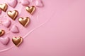Golden and pink hearts on pink backdrop, embodying warmth and elegance for romantic occasions or sophisticated