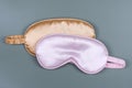 Golden and pink sleeping eye masks, top view. Good night, flight and travel concept. Sweet dreams, relax, siesta, insomnia, Royalty Free Stock Photo