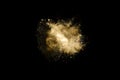 Golden powder explosion on black background. Freeze motion. Royalty Free Stock Photo
