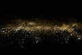 Golden powder explosion on black background. Freeze motion. Royalty Free Stock Photo