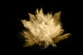 Golden powder explosion on black background.