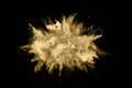 Golden powder explosion on black background.