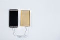 Golden powerbank with smart phone on background
