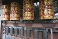 Golden prayer wheels with tibetan mantra `Om Mani Padme Hum` written on it, which means: The Jewel is in the Lotus. Prayer wheels Royalty Free Stock Photo