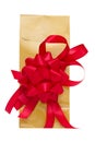 Golden present bag with red ribbon Royalty Free Stock Photo