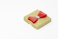Golden present box with a red bow Royalty Free Stock Photo