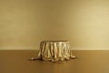 Golden product stage podium with luxury fabric on gold background. Minimal fashion. Geometry concept. Exhibition and business