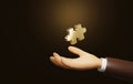 Golden puzzle on businessman`s hand illuminated on dark brown background Royalty Free Stock Photo