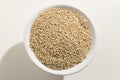 Golden Quinoa seed. Top view of grains in a bowl. White background. Royalty Free Stock Photo