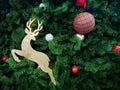 Golden Reindeer and Balls Decorated on Green Christmas Tree Royalty Free Stock Photo