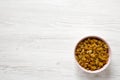 Golden Raisins in a Pink Bowl on a white wooden background, top view. Flat lay, overhead, from above. Copy space Royalty Free Stock Photo