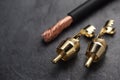 Golden RCA connector and cable on black slate background Royalty Free Stock Photo