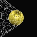golden Realistic soccer ball or football ball in net on black background. 3d Style Ball Royalty Free Stock Photo