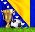 Golden realistic winner trophy cup and soccer ball isolated on national BOSNIA and HERZEGOVINA flag. National team is the winner Royalty Free Stock Photo