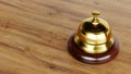 Golden Reception bell isolated on wooden background, hotel bell Royalty Free Stock Photo