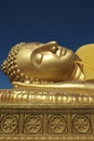 Golden reclining Buddha and Dhammajak blue sky Songkla Royalty Free Stock Photo