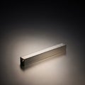 Golden Rectangular Metal Bar with White Detail on Dark Background Royalty Free Stock Photo