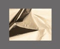Golden rectangular shape with a polished, metallic surface creates a sleek, modern design. Wrinkled