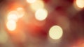 Golden and red bokeh lights create a soft, dreamy background