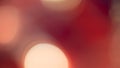 Golden and red bokeh lights create a soft, dreamy background