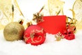 Golden and red christmas decoration on snow with wishes card Royalty Free Stock Photo