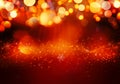 Golden red Christmas or New Year background with glitter, snowflakes, stars, bokeh gold lights on the festive gradient background Royalty Free Stock Photo